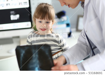 Female paediatrician working with cute little girl at her office explaining diagnosis Female paediatrician working with cute little girl at her office explaining diagnosis 53168691