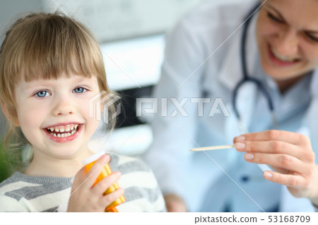 Cute smiling happy little girl hold in hand bottle of tablets at doctor office Cute smiling happy little girl hold in hand bottle of tablets at doctor office 53168709
