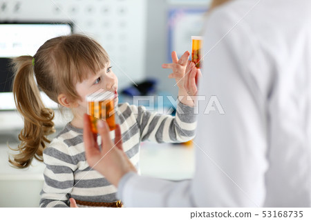 Cute little girl at doctor reception getting medications prescription Cute little girl at doctor reception getting medications prescription 53168735