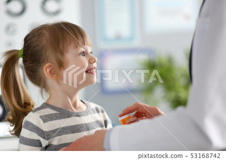 Cute little girl at doctor reception getting medications prescription Cute little girl at doctor reception getting medications prescription 53168742