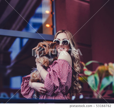 lady with dog posing in the city 53168782