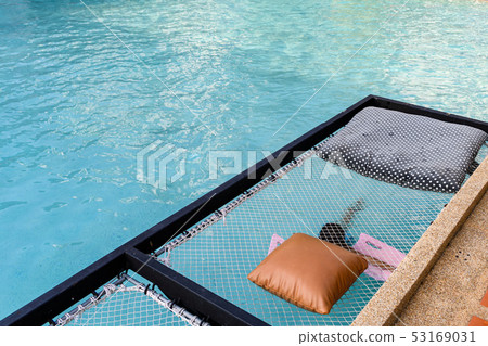 Mesh seat with pillows jut out on swimming pool Mesh seat with pillows jut out on swimming pool 53169031
