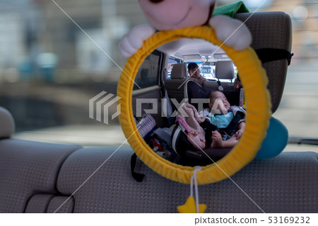Baby sitting on child seat reflected in mirror Baby sitting on child seat reflected in mirror 53169232