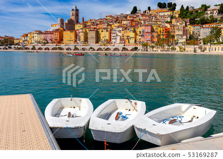 Menton. Antique multi-colored facades of medieval houses on the shore of the bay. Menton. Antique multi-colored facades of medieval houses on the shore of the bay. 53169287