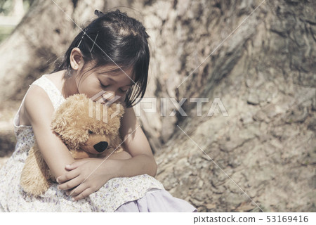 Sad girl feeling alone in the park. Lonely - Stock Photo [53169416] - PIXTA