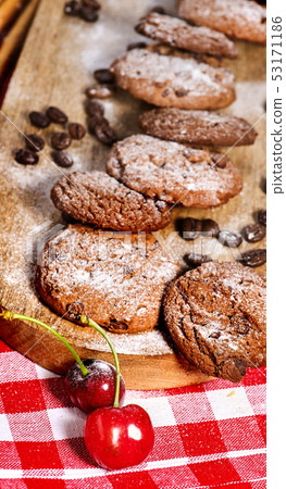 Oatmeal chocolate cookies with coffee grains and cherry. Sun flare 53171186