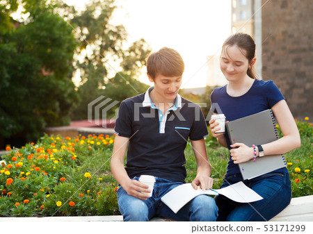 Couple of college students during a brake between Couple of college students during a brake between 53171299