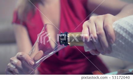 woman gets drunk at home alone at a table set for two for a romantic date, as her partner did not woman gets drunk at home alone at a table set for two for a romantic date, as her partner did not 53172040