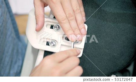 close-up, the man tightens the screw with a hex wrench. Furniture assembly close-up, the man tightens the screw with a hex wrench. Furniture assembly 53172047