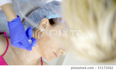 The cosmetologist makes injections, anti-aging procedures for tightening and smoothing wrinkles on The cosmetologist makes injections, anti-aging procedures for tightening and smoothing wrinkles on 53172082