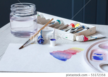 Set of watercolors, brushes, a glass of water and Set of watercolors, brushes, a glass of water and 53172358