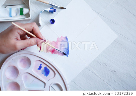 Set of watercolors, brushes and palette on a white 53172359