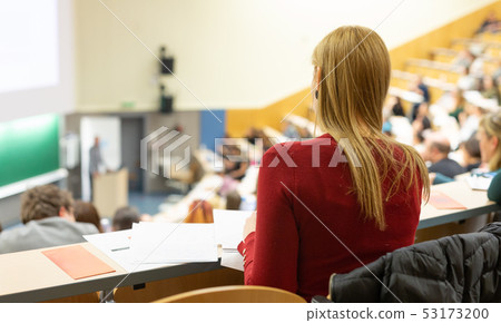 Female student attending faculty lecture workshop making notes. Female student attending faculty lecture workshop making notes. 53173200