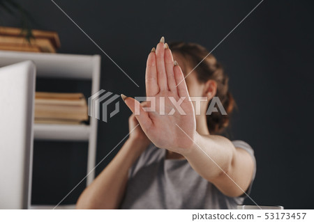 Woman talking phone and showing stop sign by her hand isolated. 53173457