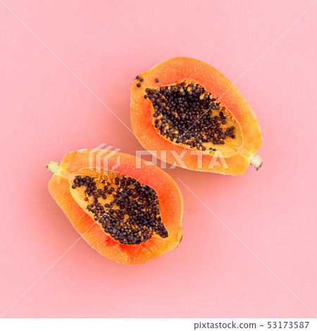 Half cut papaya on color background Half cut papaya on color background 53173587