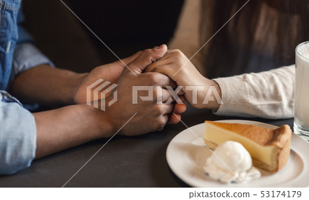 Young african american couple holding hands together at romantic date 53174179