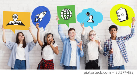 Diverse Friends Holding Up Bubbles With Social Media Icons Diverse Friends Holding Up Bubbles With Social Media Icons 53174482