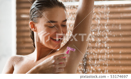 Woman Shaving Underarms, Standing Under Water Drops Woman Shaving Underarms, Standing Under Water Drops 53174697