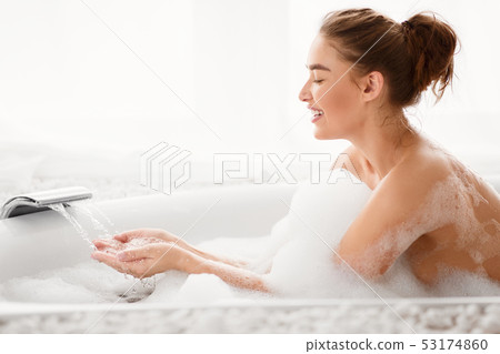 Pretty Woman Filling Bath With Water, Copy Space 53174860