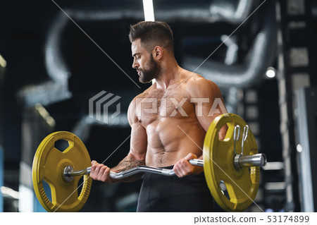 Handsome naked weightlifter lifting heavy... - Stock Photo [53174899