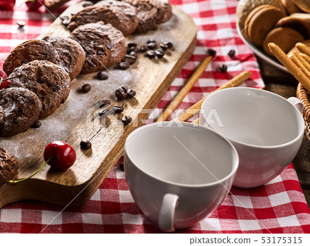 Oatmeal chocolate cookies with coffee grains and cherry. Sun flare Oatmeal chocolate cookies with coffee grains and cherry. Sun flare 53175315