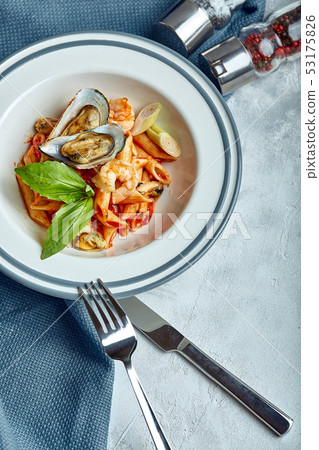 Pasta with seafood and tomato sauce. Penne with shrimp, octopus, mussels, Vongli in tomato sauce Pasta with seafood and tomato sauce. Penne with shrimp, octopus, mussels, Vongli in tomato sauce 53175826