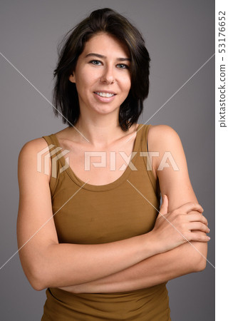 Young beautiful woman against gray background 53176652
