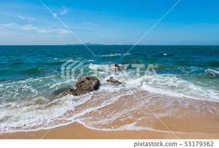 The waves hit the rocks in the blue sea The waves hit the rocks in the blue sea 53179362