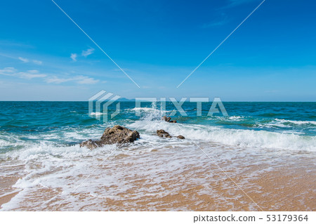 The waves hit the rocks in the blue sea The waves hit the rocks in the blue sea 53179364