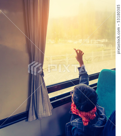 Asian kid sit on back seat in bus . Asian kid sit on back seat in bus . 53180385