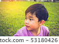 boy looking on left side in park. 53180426