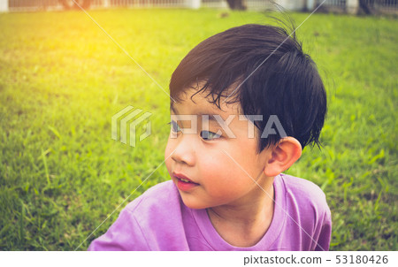 boy looking on left side in park. 53180426