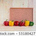 sweet peppers on wooden table. 53180427
