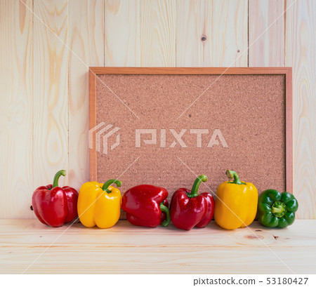 sweet peppers on wooden table. sweet peppers on wooden table. 53180427