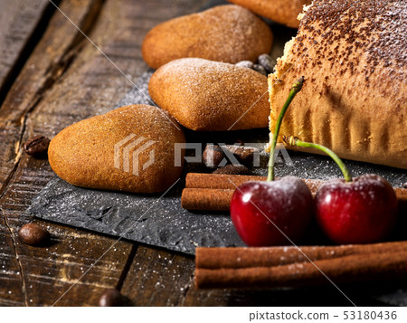 Sand cookies heart shape and rolled cake with cherry and coffee bean Sand cookies heart shape and rolled cake with cherry and coffee bean 53180436