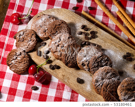 Oatmeal chocolate cookies with coffee grains and cherry. Sun flare Oatmeal chocolate cookies with coffee grains and cherry. Sun flare 53180461