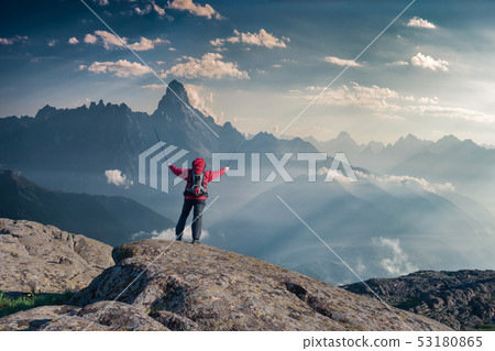 Mountaineer with backpack on rock Mountaineer with backpack on rock 53180865
