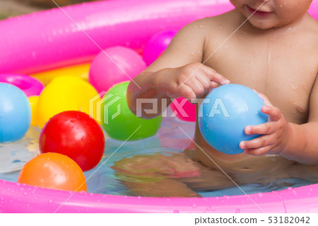 Close up hands baby playing colorful balls. Close up hands baby playing colorful balls. 53182042