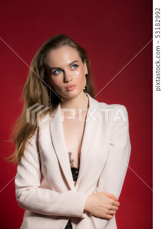 portrait of a young sexy blonde woman on a red bac 53182992