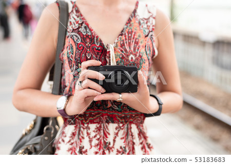 mature Asian woman using digital camera mature Asian woman using digital camera 53183683