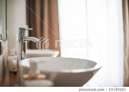 Modern stylish washbasins with chrome taps. Luxury lifestyle. Close-up, selective focus Wood texture Modern stylish washbasins with chrome taps. Luxury lifestyle. Close-up, selective focus Wood texture 53185081