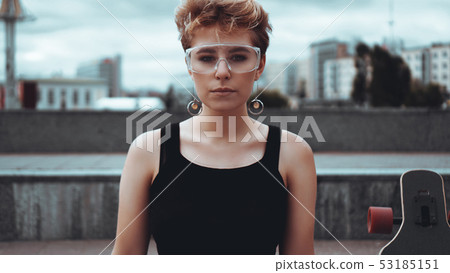 Young woman with trendy short blonde hair outdoor portrait Young woman with trendy short blonde hair outdoor portrait 53185151