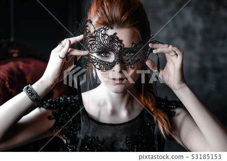 Attractive woman in black dress in medieval interior Attractive woman in black dress in medieval interior 53185153