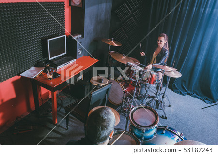 Woman receiving drum lessons from her music teacher 53187243