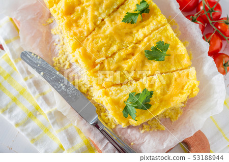 Polenta served on wood board with cherry tomatoes Polenta served on wood board with cherry tomatoes 53188944