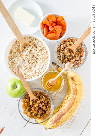 Granola ingredients on white wood background 53189248
