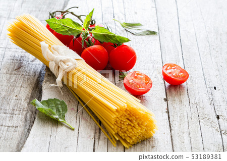 Raw pasta, tomato, basil Raw pasta, tomato, basil 53189381