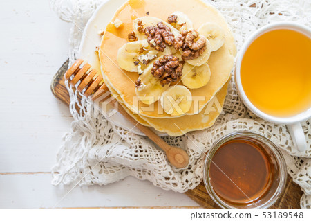 Pancakes with banana, nuts and honey 53189548