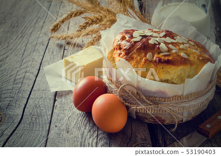 Easter bread and ingredients on rustic wood background 53190403