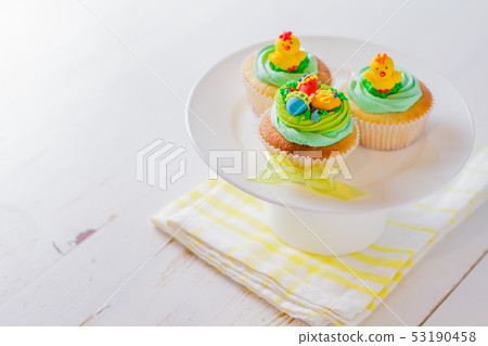 Easter cupcakes on white wood background Easter cupcakes on white wood background 53190458